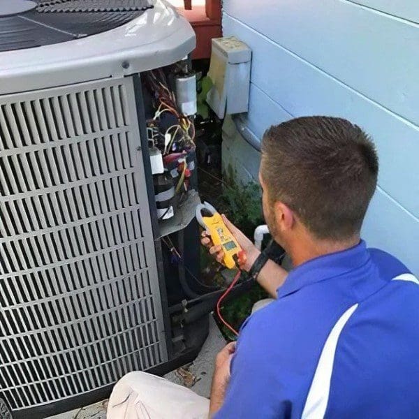HVAC Repair Technician Working on an Air Conditioner Unit An HVAC repair technician is working on a residential air conditioner unit, performing repairs or maintenance to ensure proper functionality