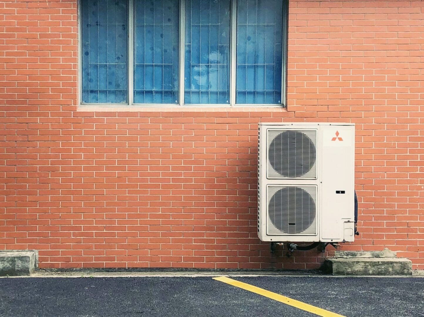 air conditioner repair Jacksonville A ductless air conditioner is mounted on a wall, providing efficient cooling for the room without the need for ductwork