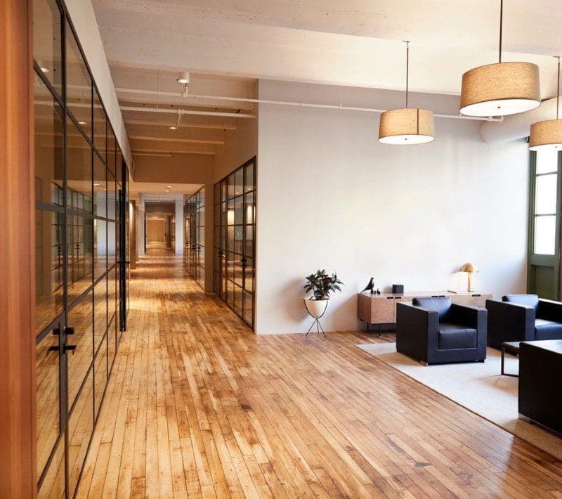 A room with many windows and wooden floors