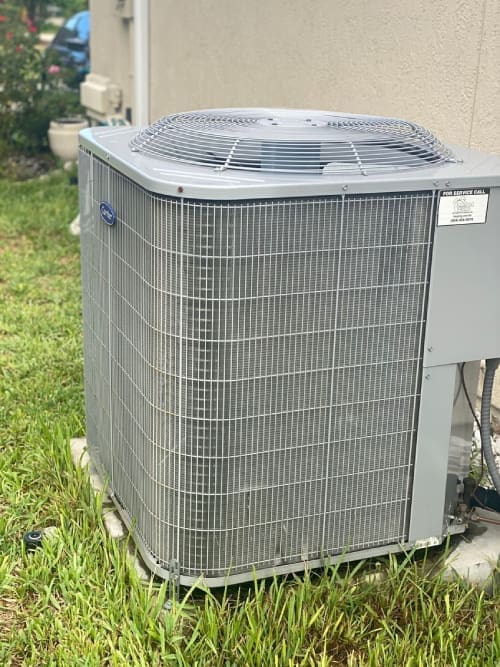 A close-up view of an air conditioning unit in Callahan, Florida, showcasing the external components of the system, including the condenser and fan