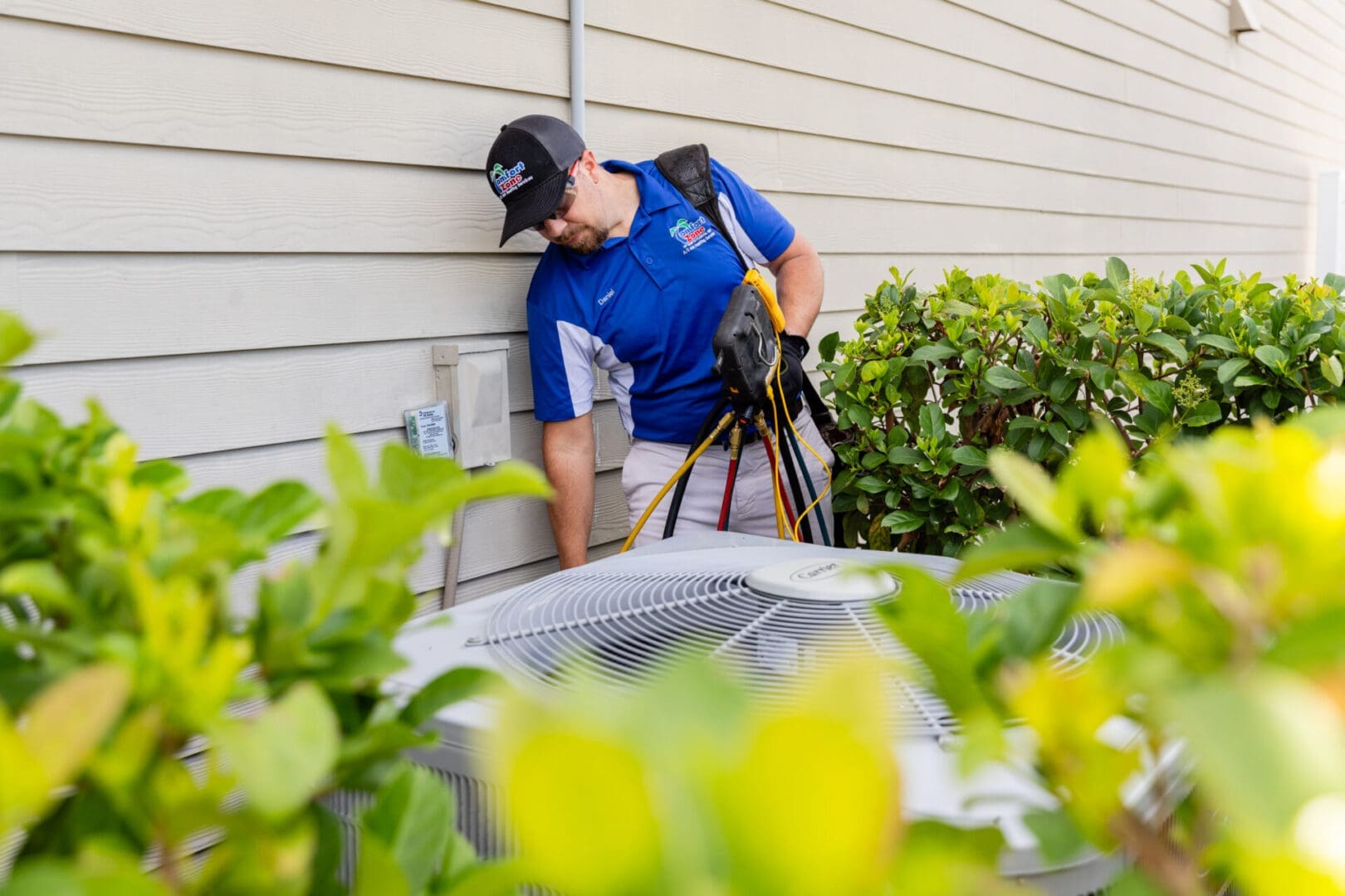 Expert HVAC Technician Analyzing a Heat Pump in Yulee, Florida An expert HVAC technician is carefully inspecting and analyzing a heat pump system outside a home in Yulee, Florida, using diagnostic tools to ensure proper operation.