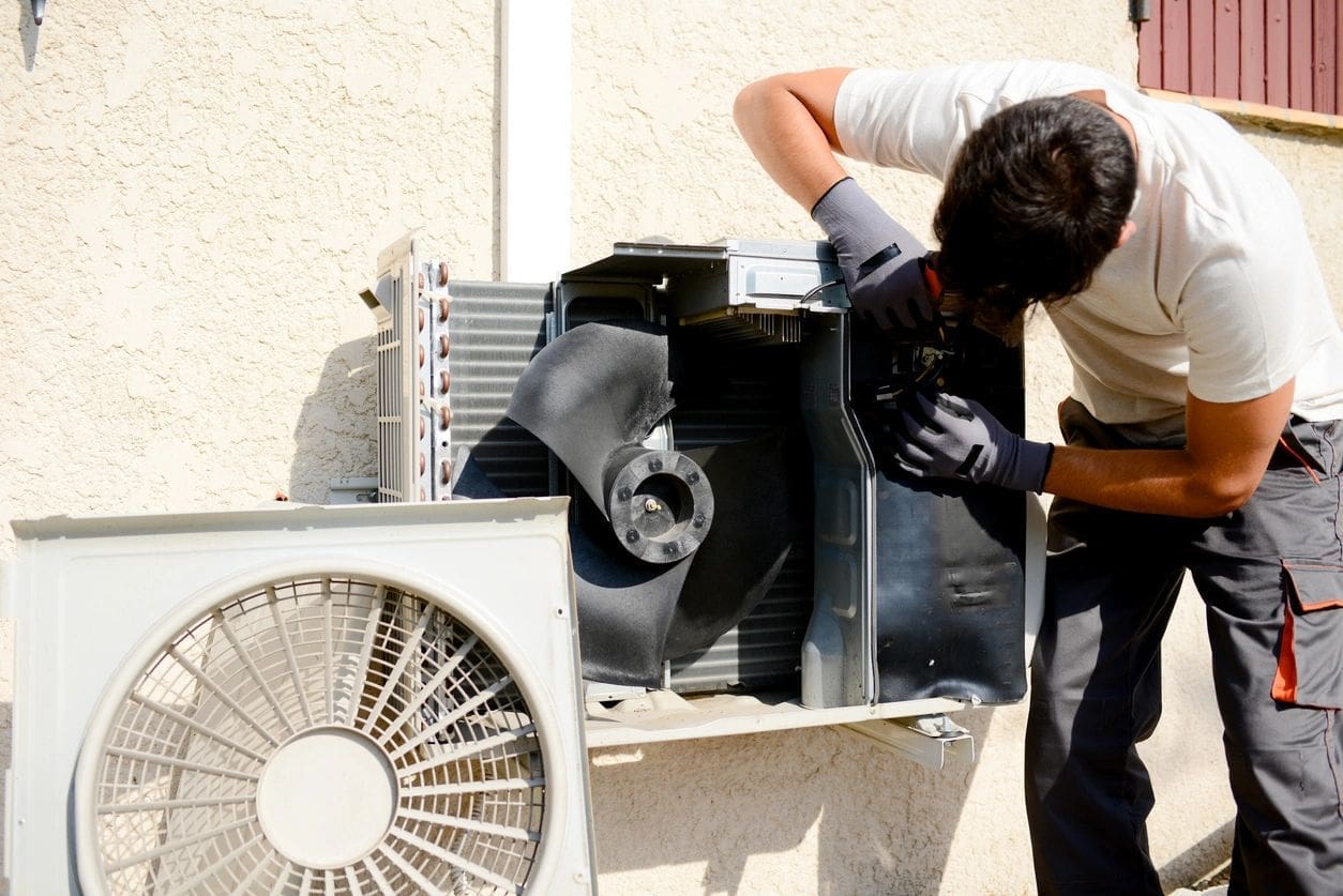 Ductless unit repair Air conditioning man repairing an electrical component on a ductless mini split unit
