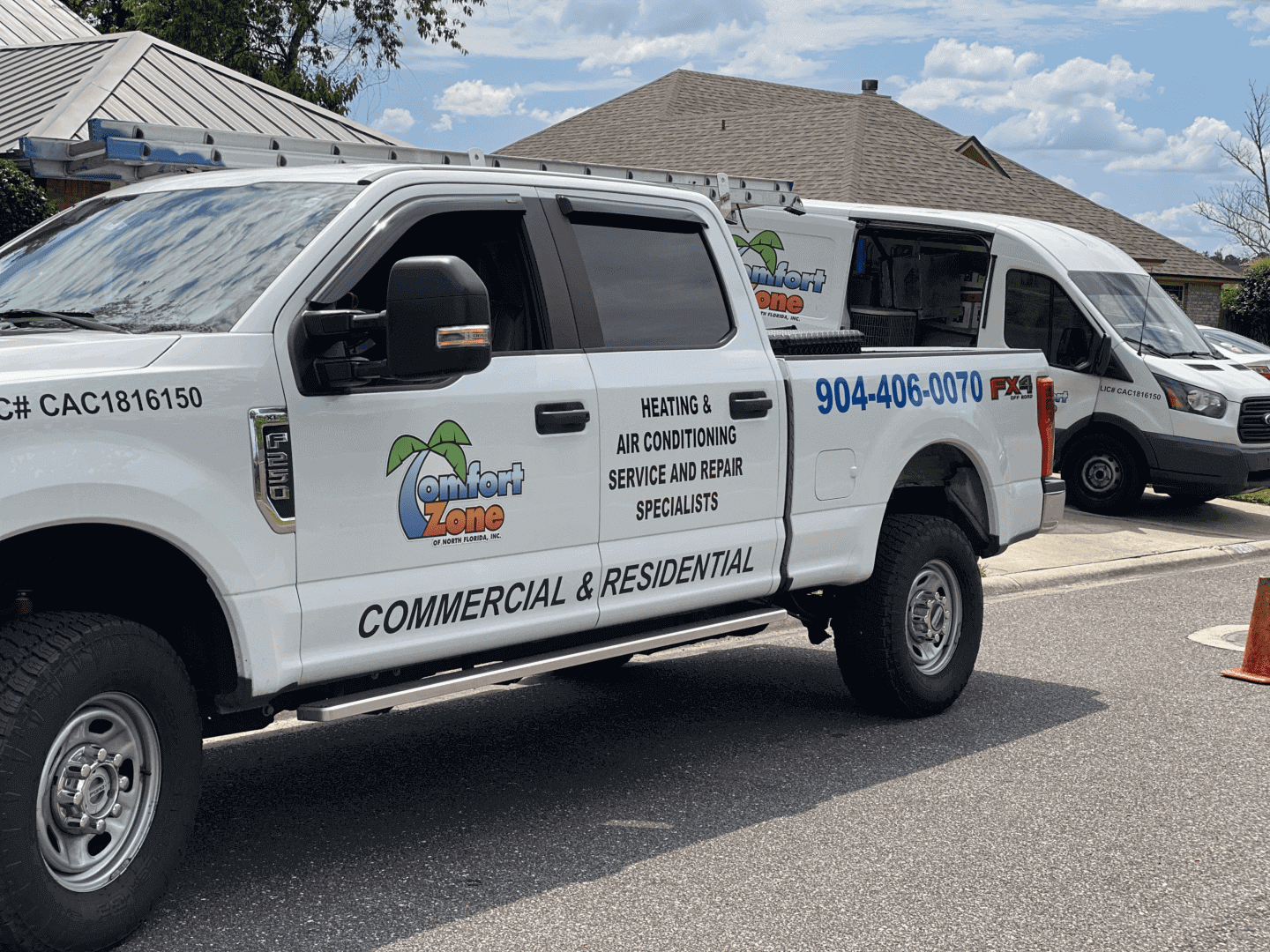 Comfort zone Air Conditioning Company Comfort Zone of North Florida Company vehicles parked in front of a residential home during an air conditioning installation