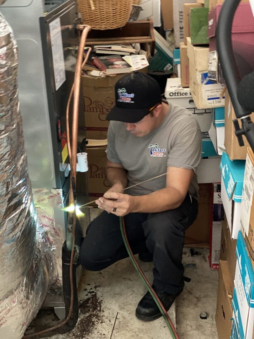 AC tech welding in a unit Air Conditioning technician welding in an ac unit on a new installation