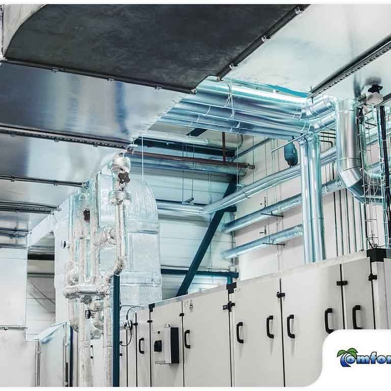 Commercial Space with Metal Ventilation Pipes on Ceiling A large commercial space featuring metal ventilation pipes installed across the ceiling, showcasing the building's HVAC system