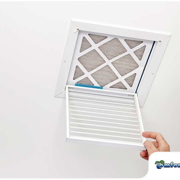 AC Repairman Opening Air Filter in Ceiling An AC repairman is opening up an air filter in the ceiling, preparing to clean or replace it for better airflow and system efficiency