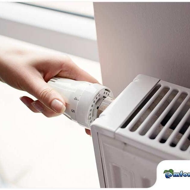 A person is holding an air conditioner in their hand.