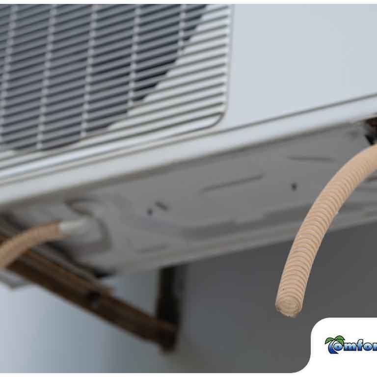 Close-Up of Air Conditioner Drainage Pipes A close-up view of an air conditioner unit's drainage pipes, highlighting the system's components for removing condensation