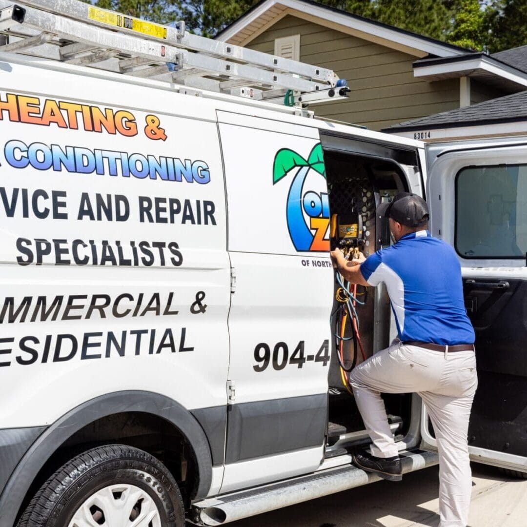 Comfort Zone of North Florida Air Conditioning Tech getting parts out of company van for a repair