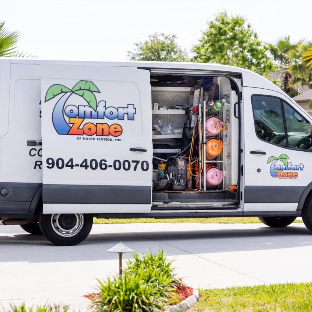 A white comfort zone air conditioning van with palm trees in the back.