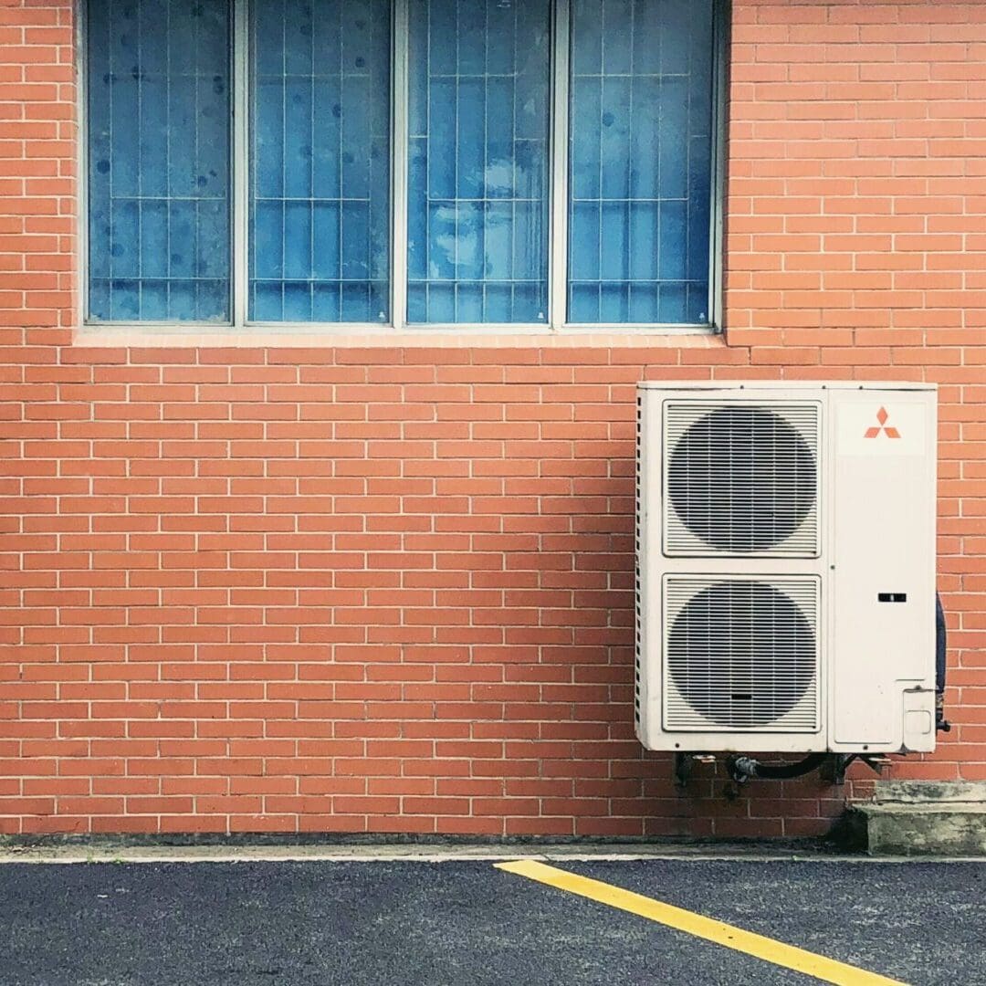 A ductless air conditioner is mounted on a wall, providing efficient cooling for the room without the need for ductwork