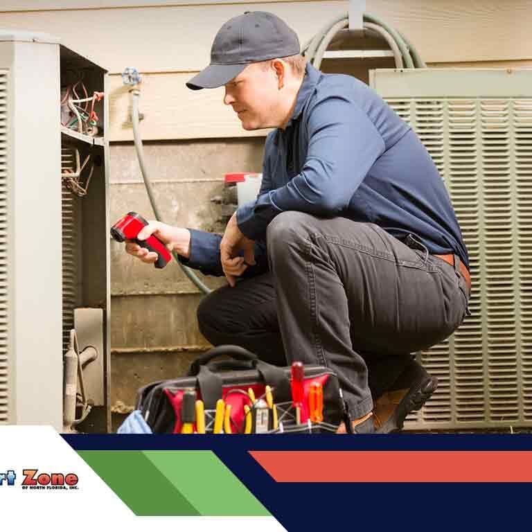 An HVAC technician is repairing a heating unit, troubleshooting and fixing components to restore proper heating functionality