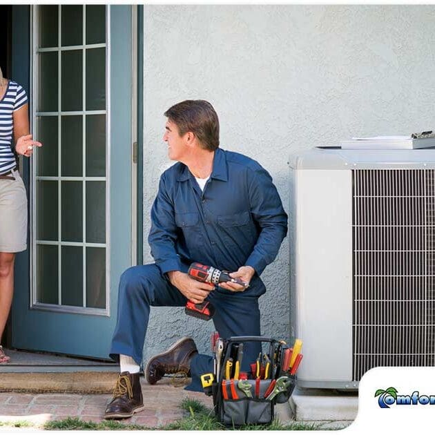 e6b20faf5f7991aa4780b05a02b32a49b2a23531-lady-homeowner-discussing-with-hvac-technician An AC repairman is sitting on the ground next to an air conditioner in Jacksonville, Florida, discussing repair options with a homeowner to resolve the issue.