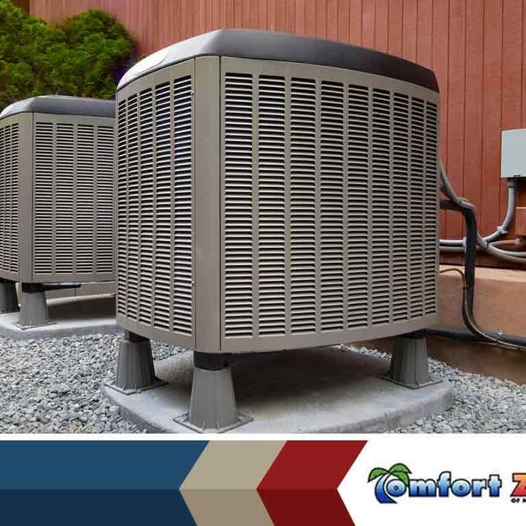 Two air conditioning units are positioned outside of a building, providing cooling for the structure
