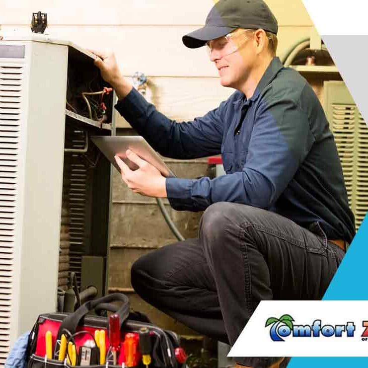 A HVAC repairman is working on an air conditioning unit outside, performing maintenance or repairs to ensure proper function