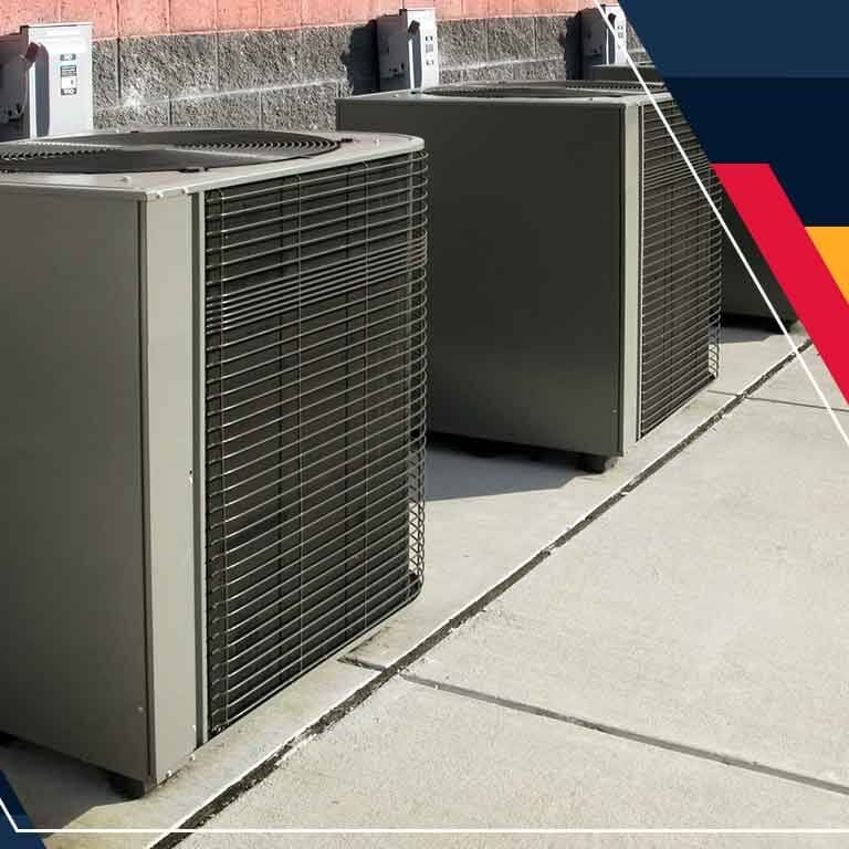 Two Air Conditioners on the Sidewalk Two air conditioning units are positioned on the sidewalk, providing cooling for the nearby space
