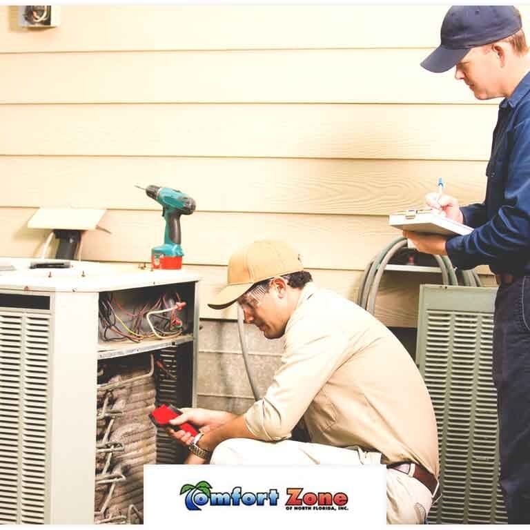 Two HVAC Service Technicians Working on an HVAC System in Summer Two HVAC service technicians are working on an HVAC system during the summer, ensuring the system operates efficiently to provide cool indoor air