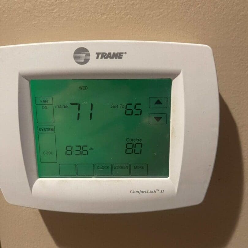 Touchscreen Thermostat A WiFi enabled digital programmable touchscreen AC thermostat is shown on the wall during a routine maintenance